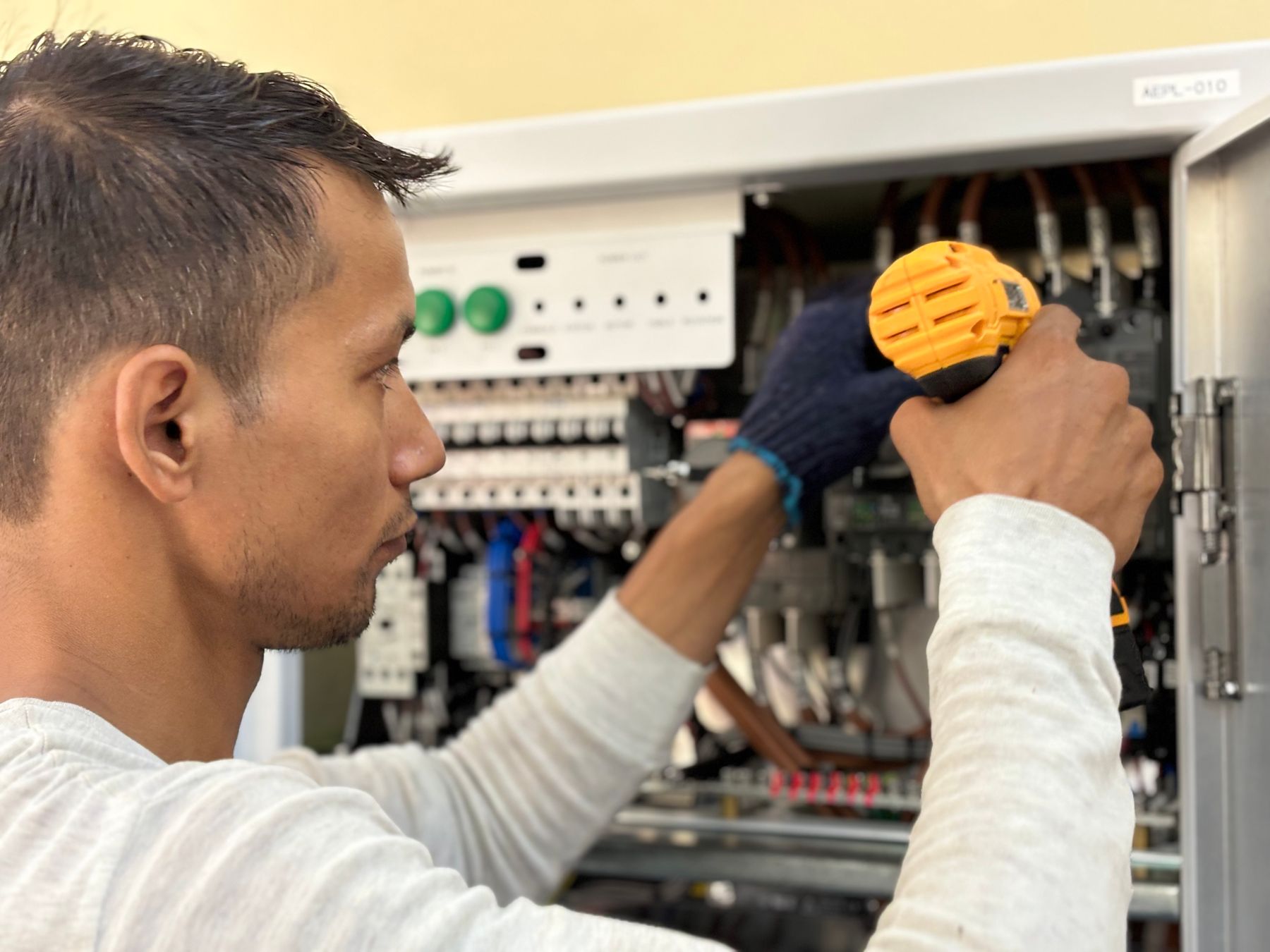 Electrician servicing electrical equipment